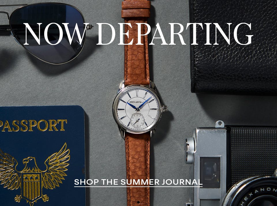 Flat lay of luxury travel essentials featuring a pre-owned Girard-Perregaux moonphase watch, vintage camera, designer glasses, and fragrance—evoking refined summer departure style.