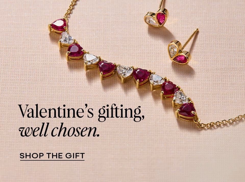 Fine jewelry Valentine's Day curation featuring ruby and diamond heart earrings with a coordinating necklace