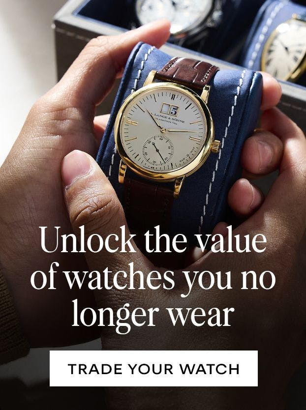 Three luxury watches on leather straps displayed on a wooden surface, with text "Refresh Your Collection with a Trade" and "GET STARTED NOW" for trading in watches at The 1916 Company