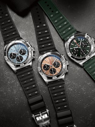 Breitling Chronomat B01 42 watches with different dial colors (light blue, bronze, and green) and matching rubber straps, for sale at The 1916 Company.