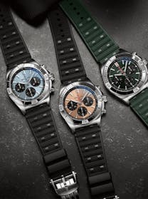 Breitling Chronomat B01 42 watches with different dial colors (light blue, bronze, and green) and matching rubber straps, for sale at The 1916 Company.