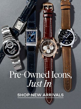 A flat lay of luxury watches against a dark background, with text "PRE-OWNED ICONS, JUST IN" and "SHOP NEW ARRIVALS"