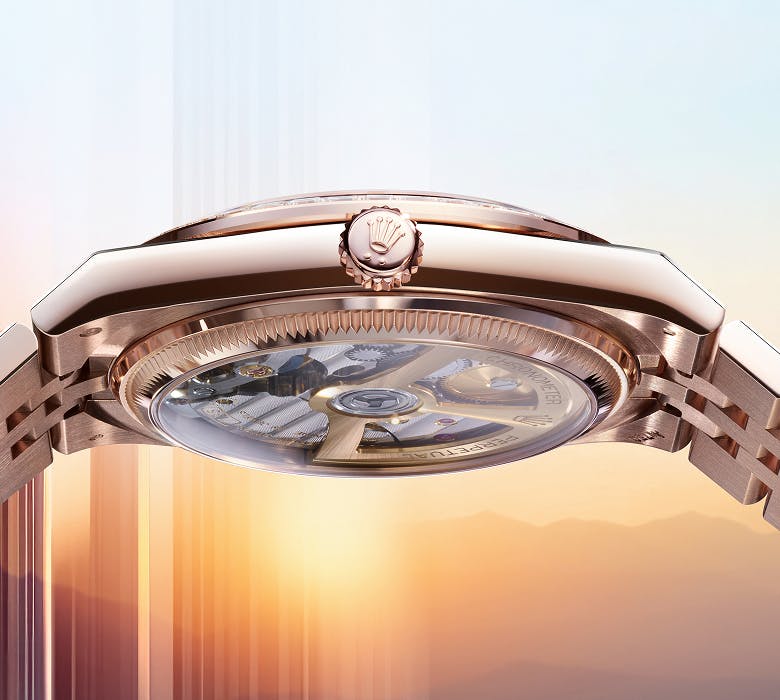 A close up of rose gold Rolex Land-Dweller side view 