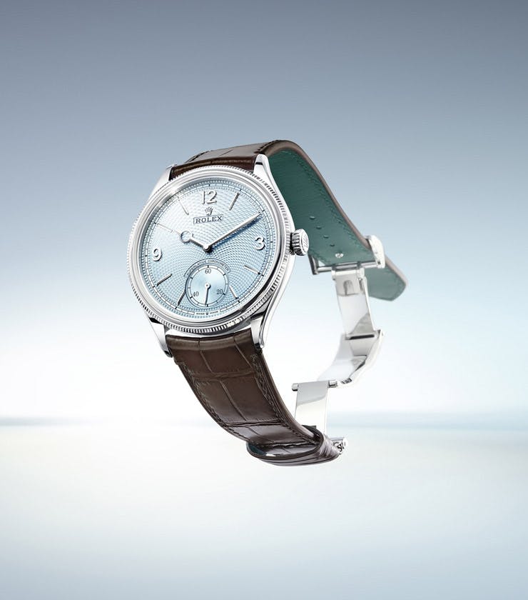 Rolex Perpetual 1908 in the air with open clasp and blue dial