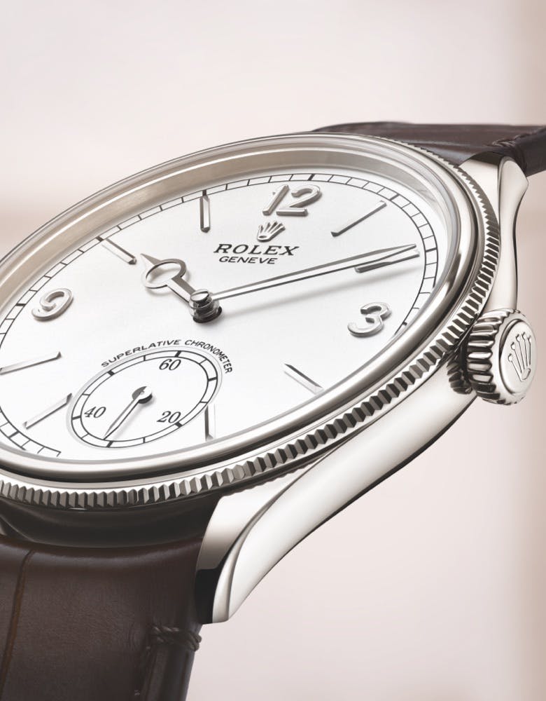 Rolex Perpetual 1908 watch close-up white dial and silver case on a brown leather strap