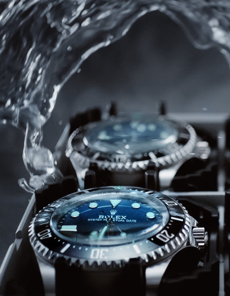 Rolex Deepseas within a case getting splashed with water