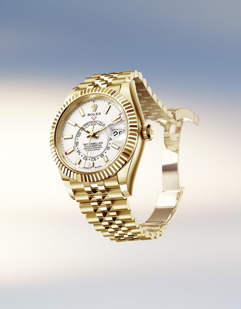 A Rolex Sky-Dweller watch with a white dial and gold bracelet, displayed against a gradient background resembling the sky.